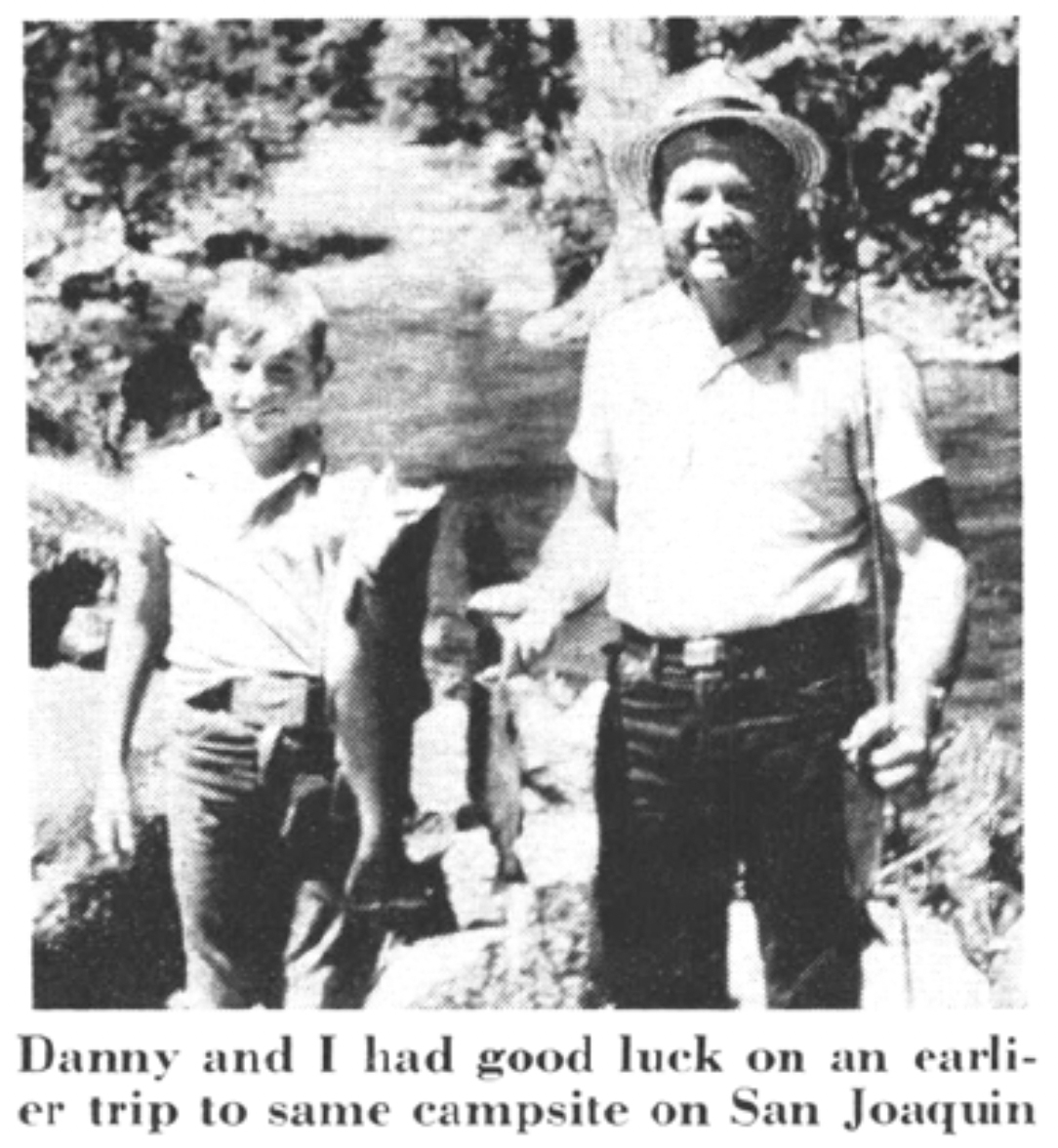 A black and white photo of a father and son holding trout.