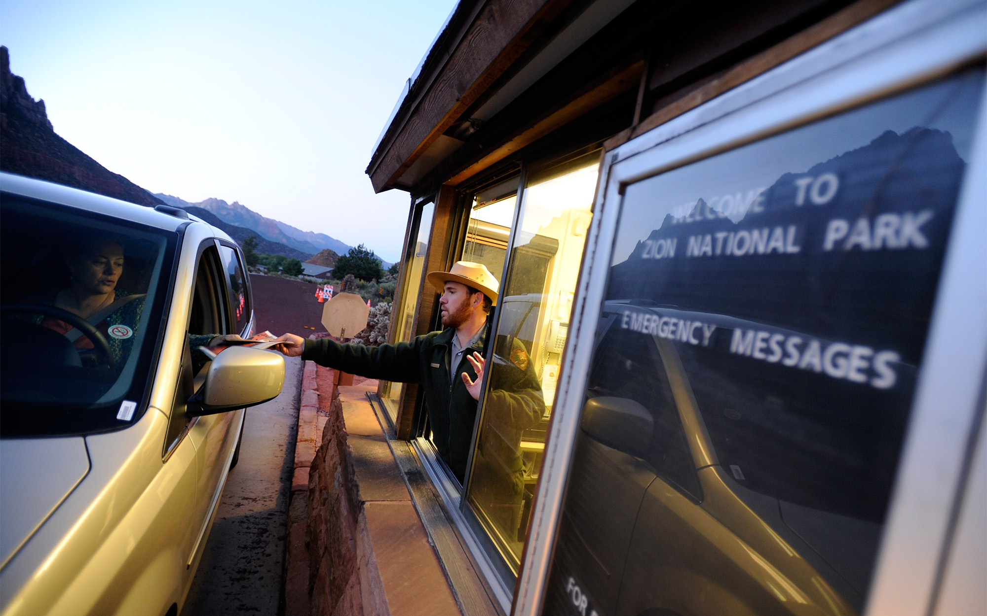 An NPS ranger greets a visitor in Zion National Park.