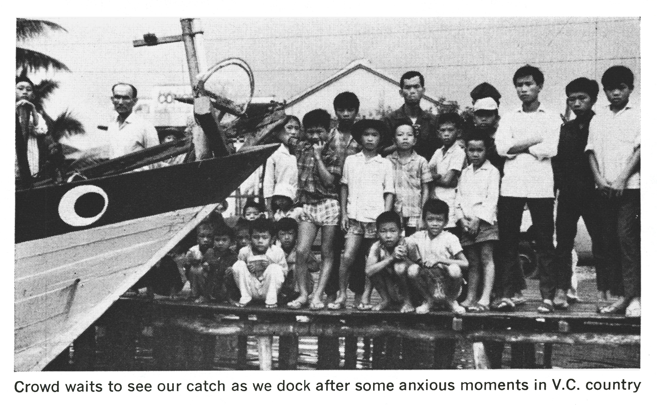 An old black and white photo of vietnamese villagers.