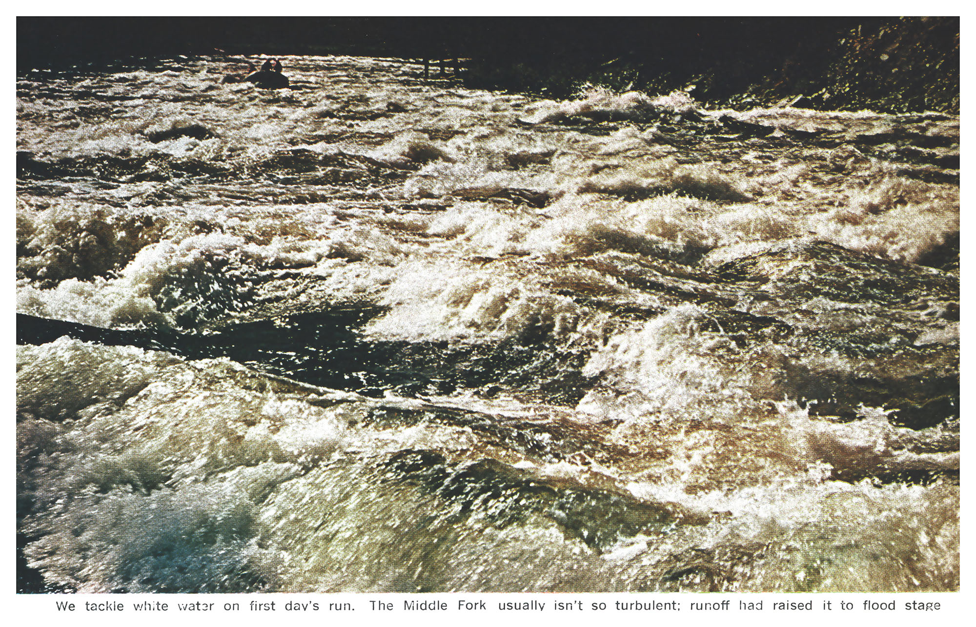 A wide expanse of violent, foaming whitewater fills the river channel, with a tiny raft barely visible far upstream.