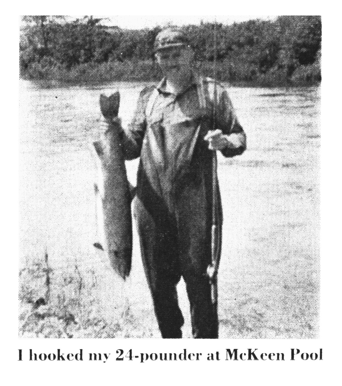 A black and white photo of a man holding up a salmon