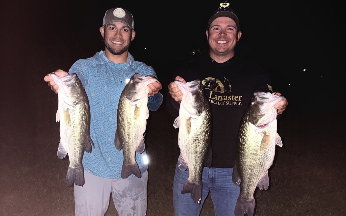 The author and his fishing partner hold up four big bass caught on Lab Series