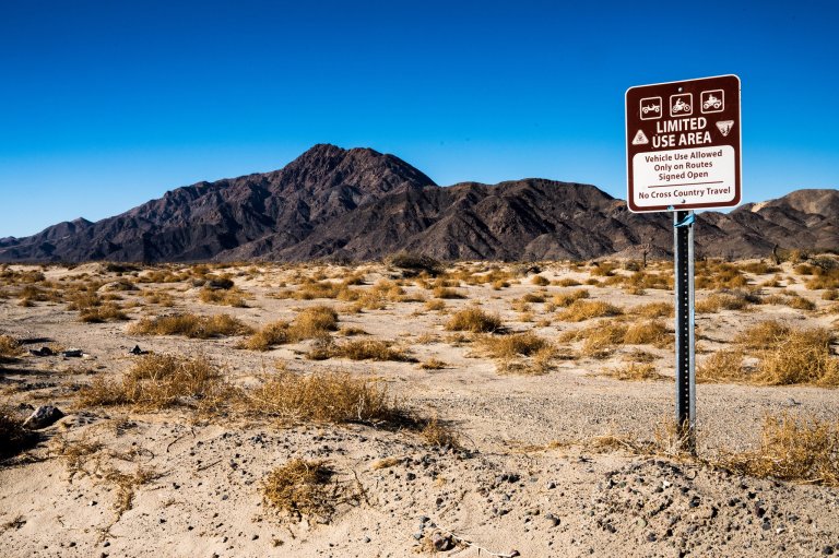 A sign with some OHV restrictions