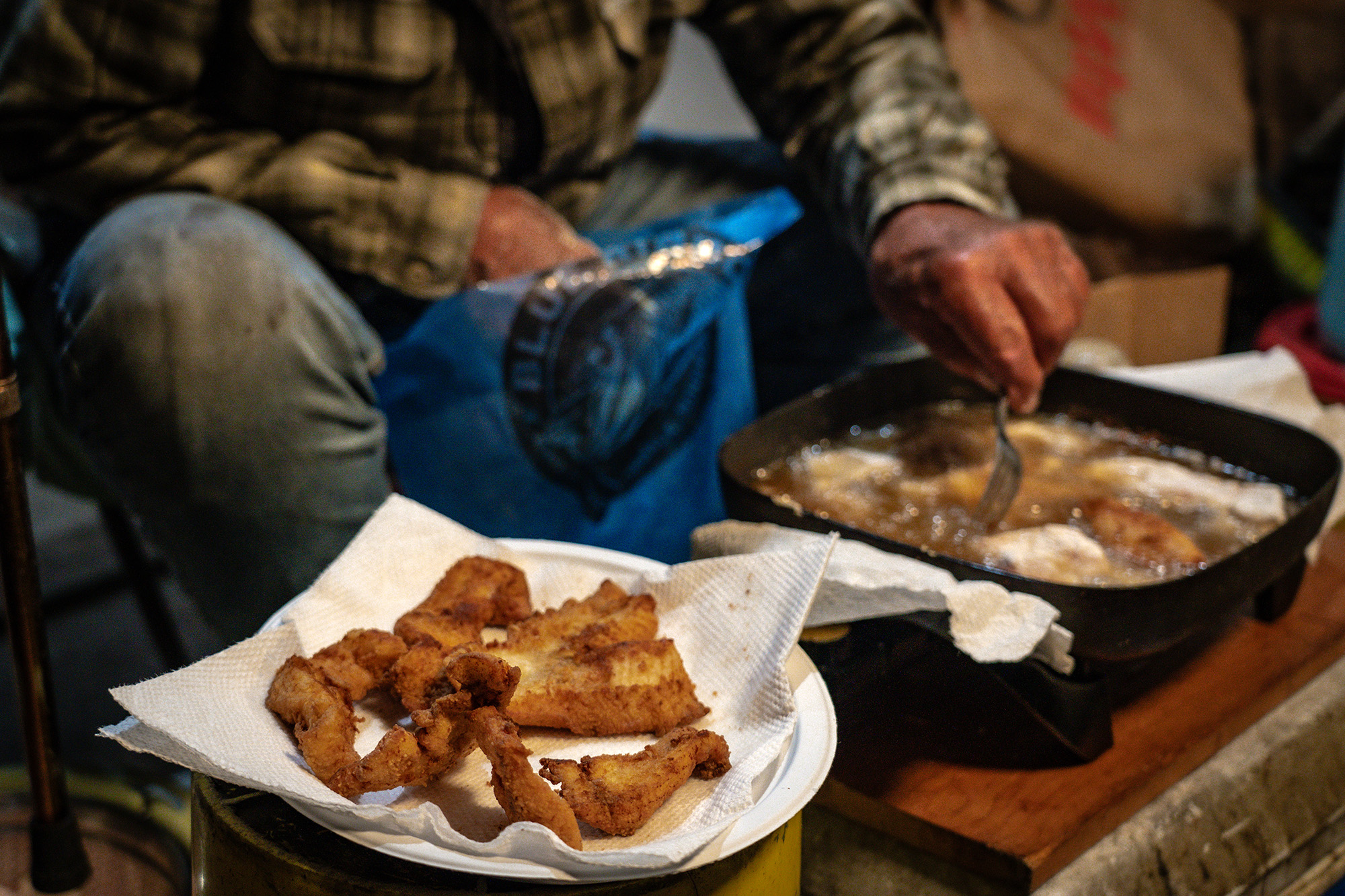 Frying pike in a pan and setting them aside on the paper towel.