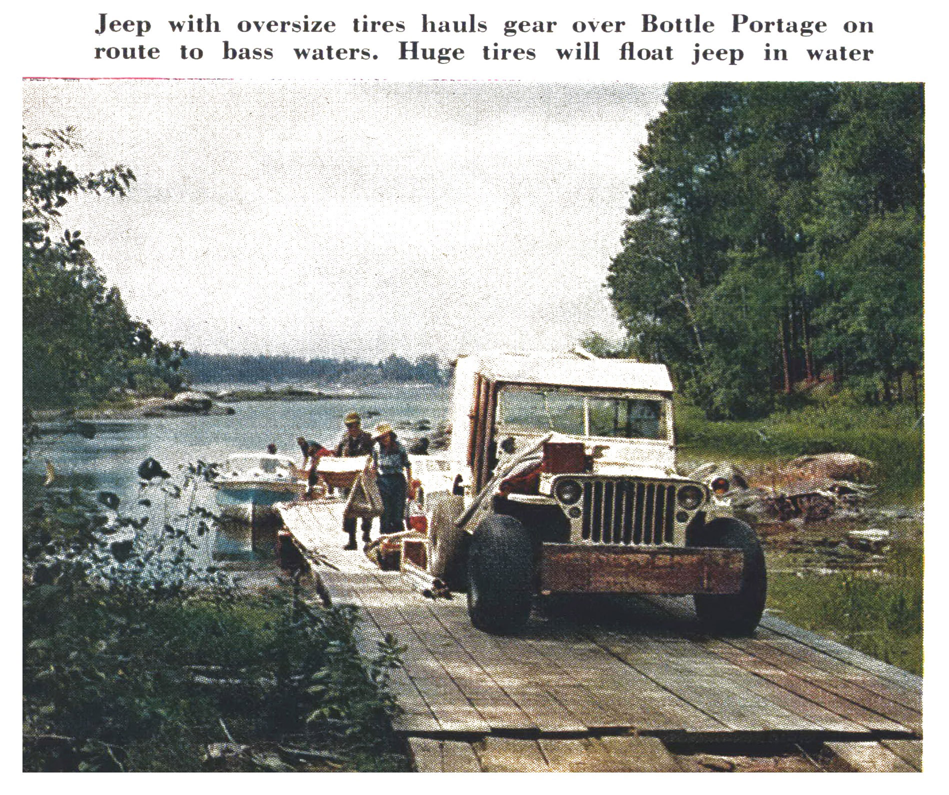A jeep on oversize balloon tires hauls fishing gear across the plank crossing at Bottle Portage beside the water.