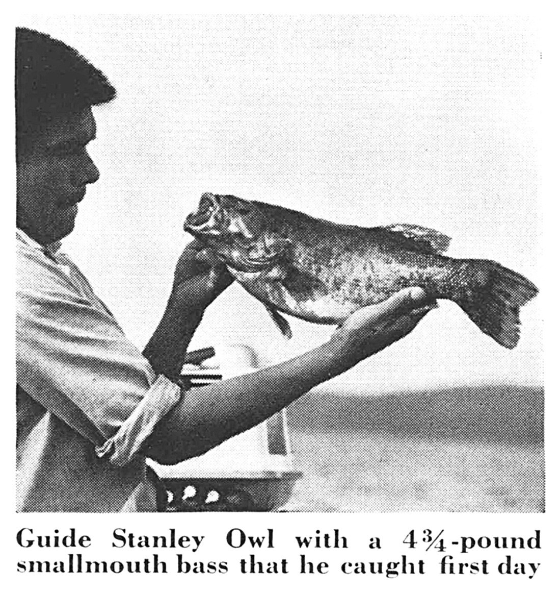 Guide Stanley Owl holds up a 4¾-pound smallmouth bass (black-and-white photo).