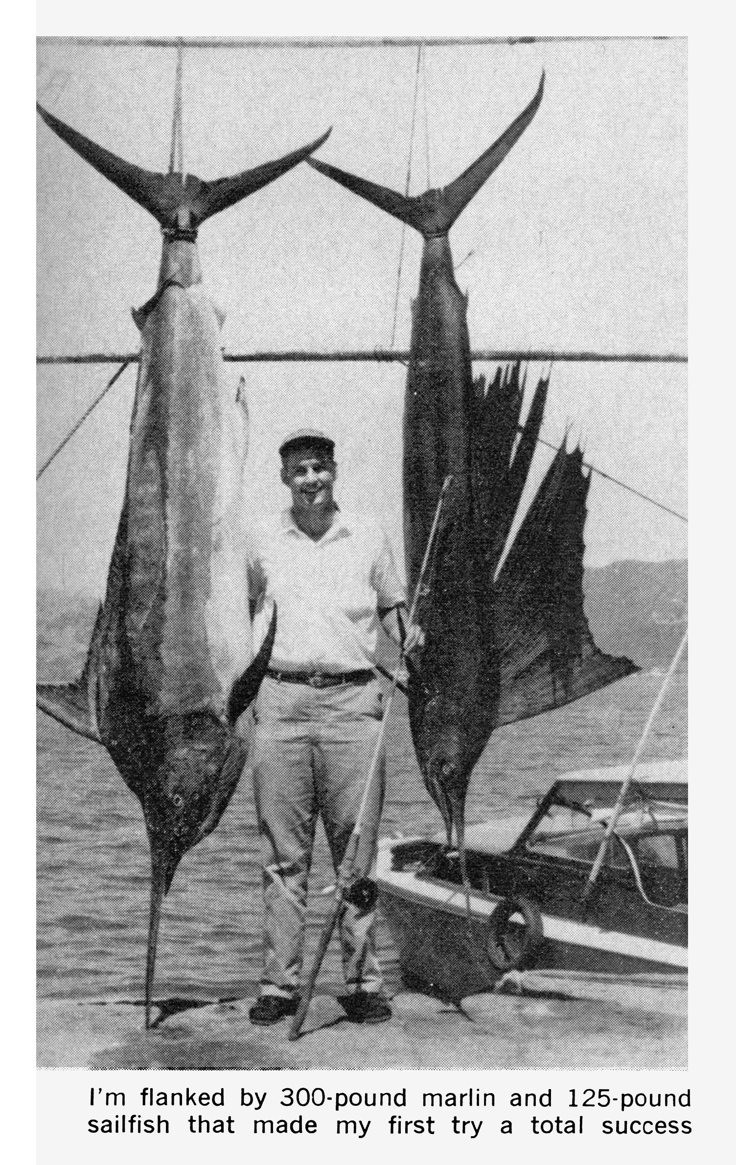 A black and white photo of a school teacher with a black marlin and a sailfish caughti n Mexico