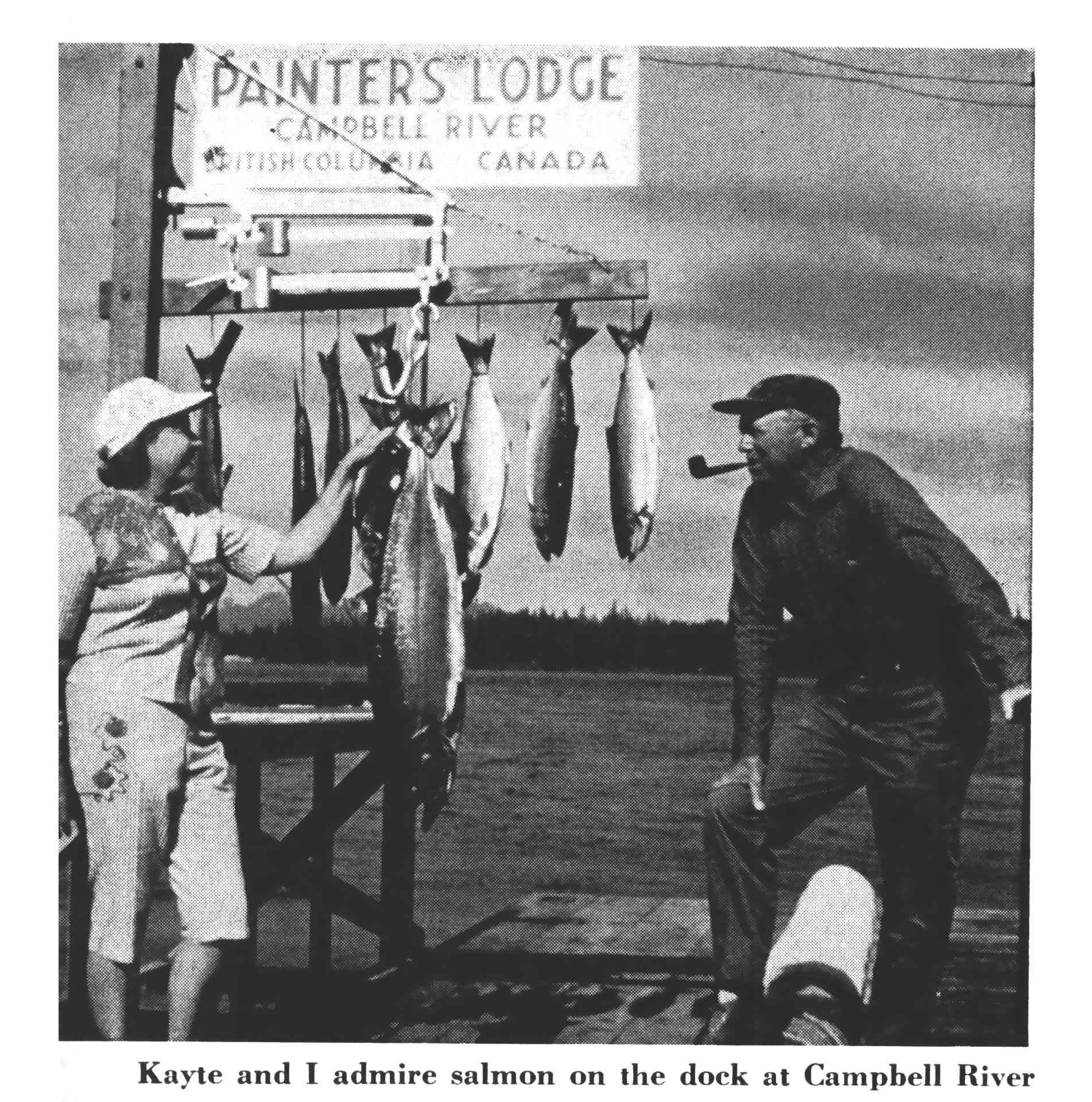A vintage black and white photo of a woman admiring salmon at Painter's Lodge along the Campbell River.