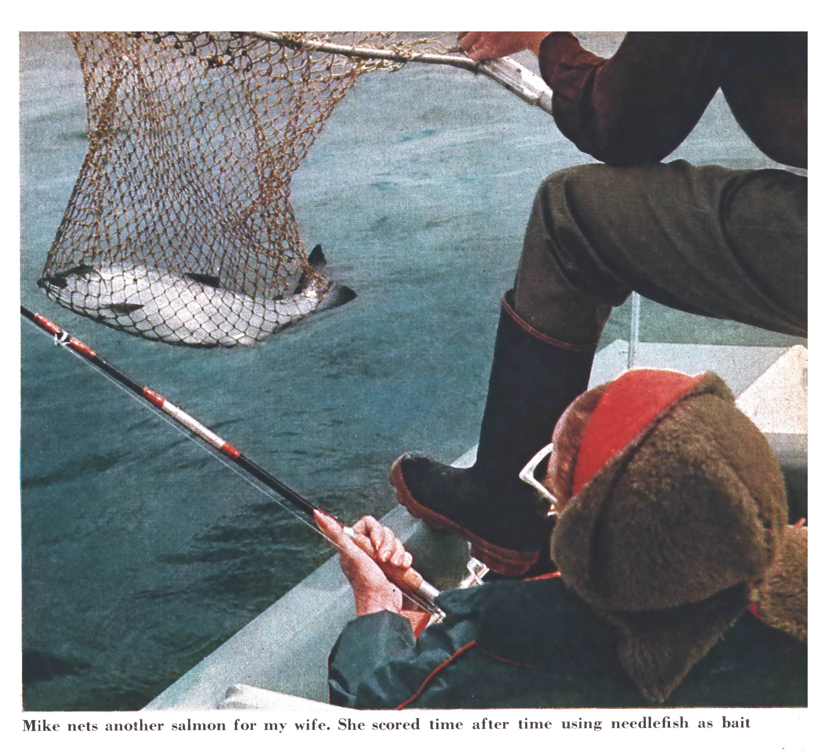 A vintage color film photo of a woman landing a salmon and her guide netting it.