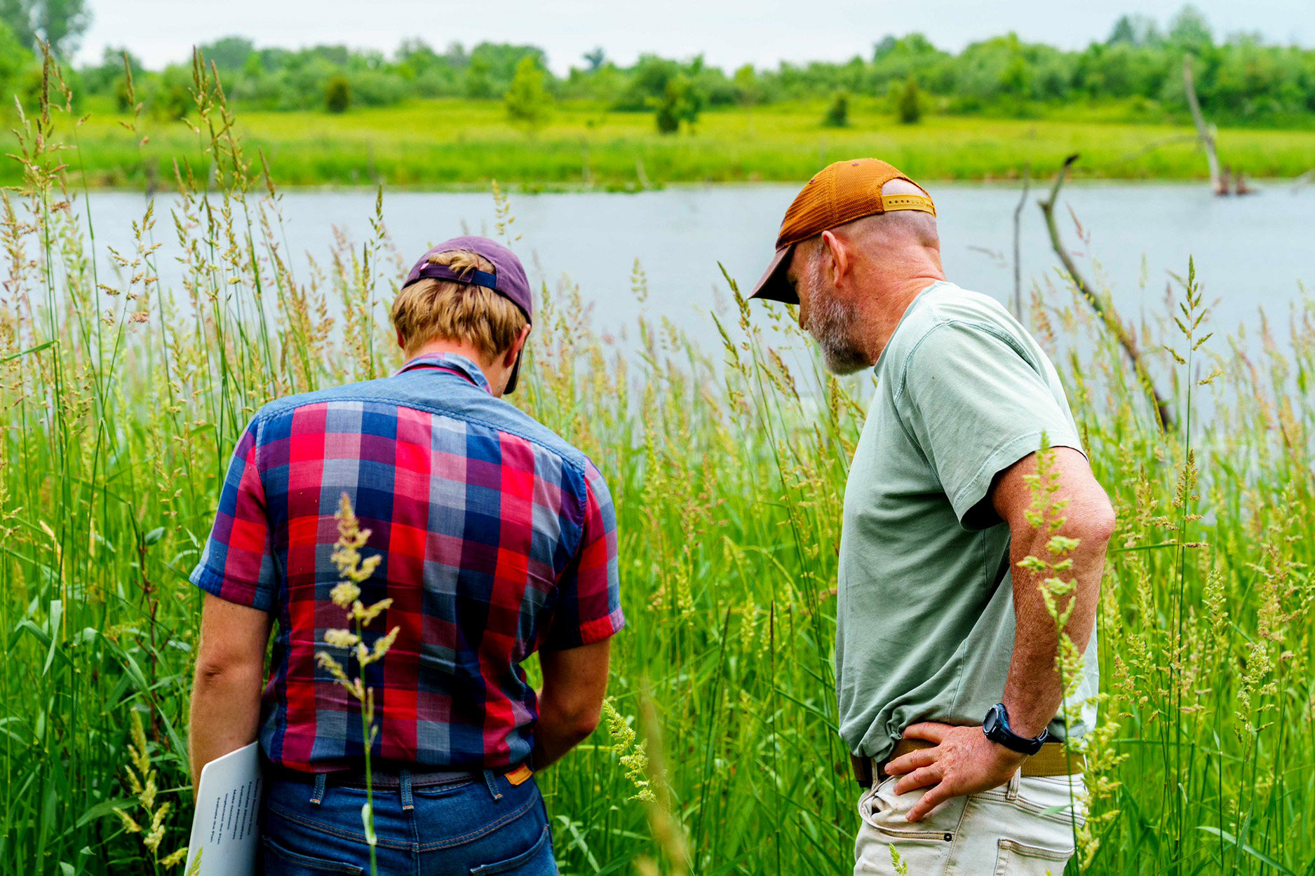 A natural resource professional works with a farmer.