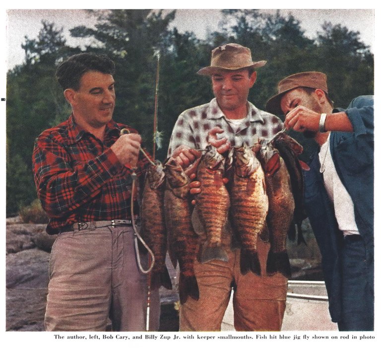 A vintage film color photograph of a trio of men holding up a stringer of nice smallmouth bass