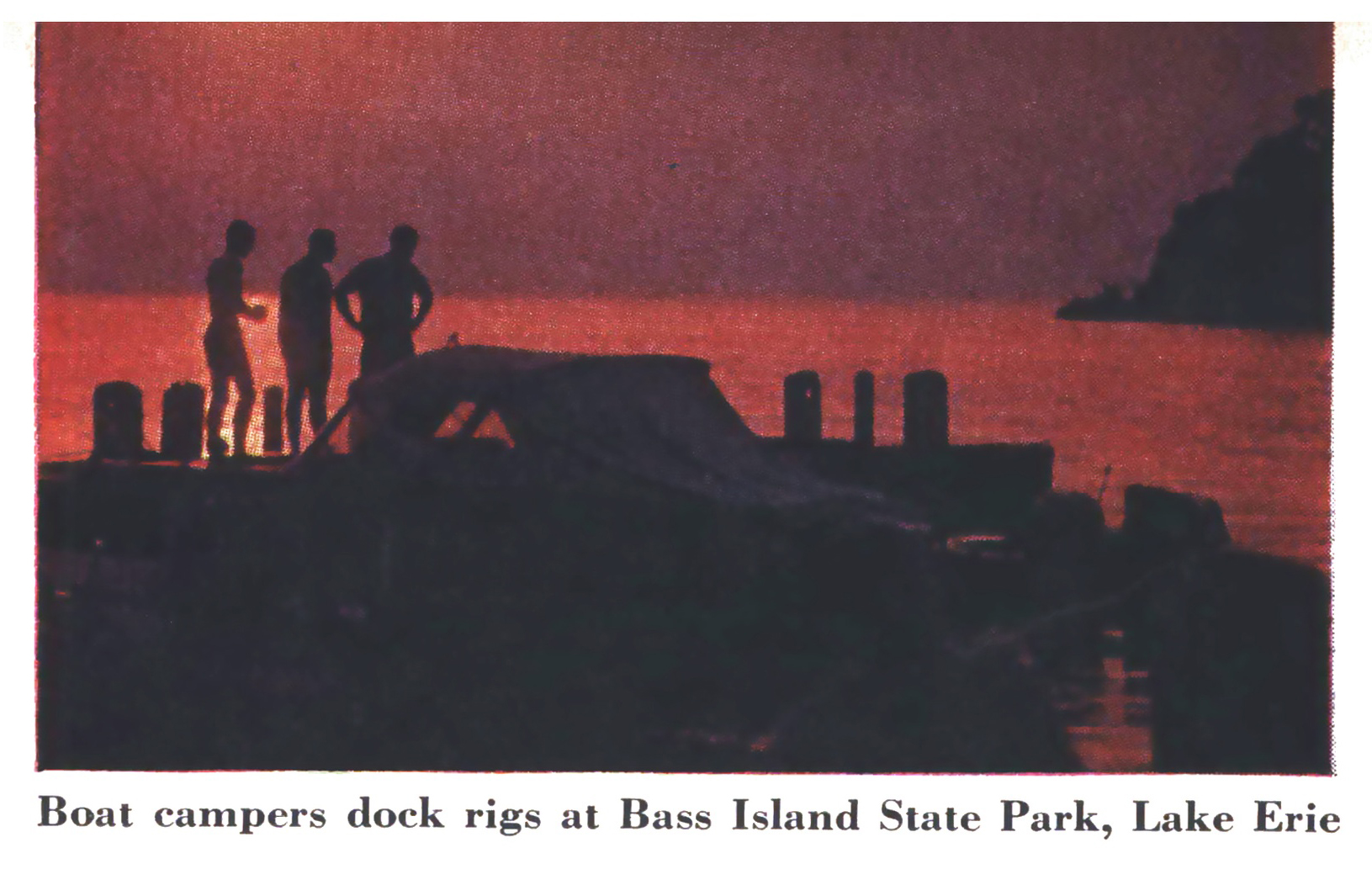 A vintage photo of a sunset and a boat.