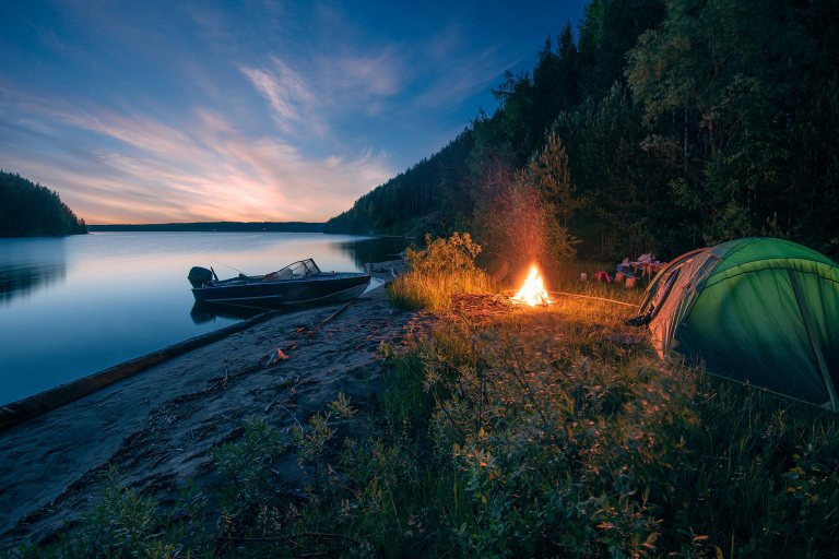 Boat camping on a riverbank.