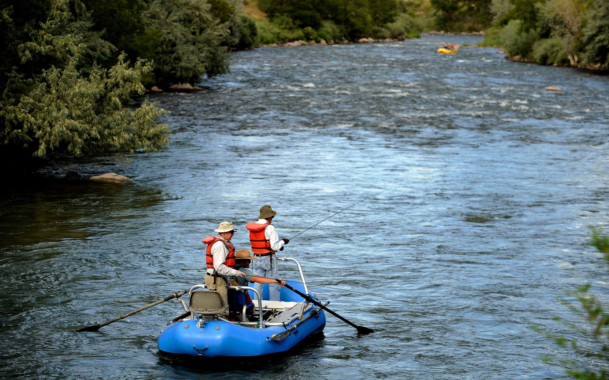 A guide rowing a raft on the Arkansas River in Colorado.