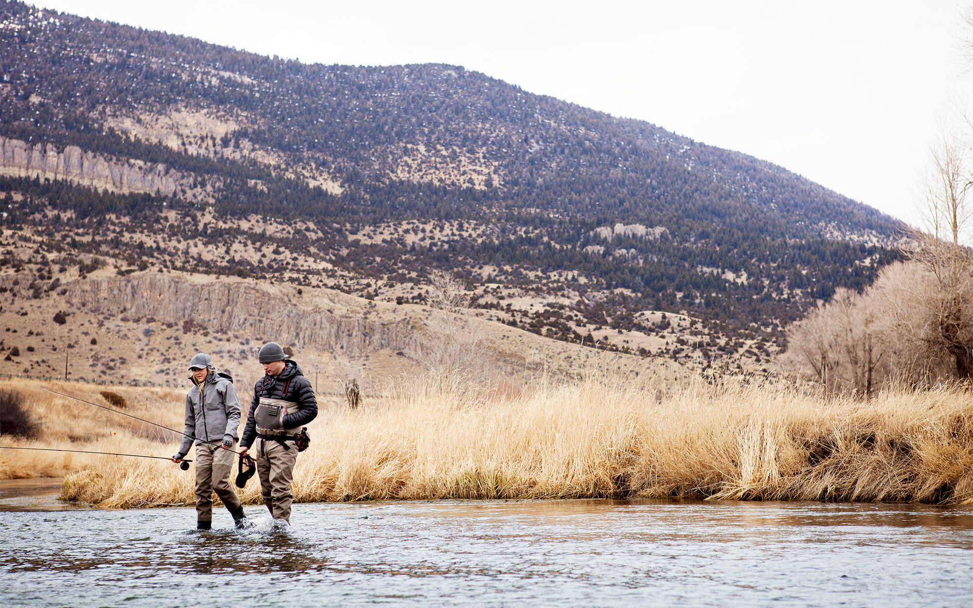 Two wade fishermen in a river.