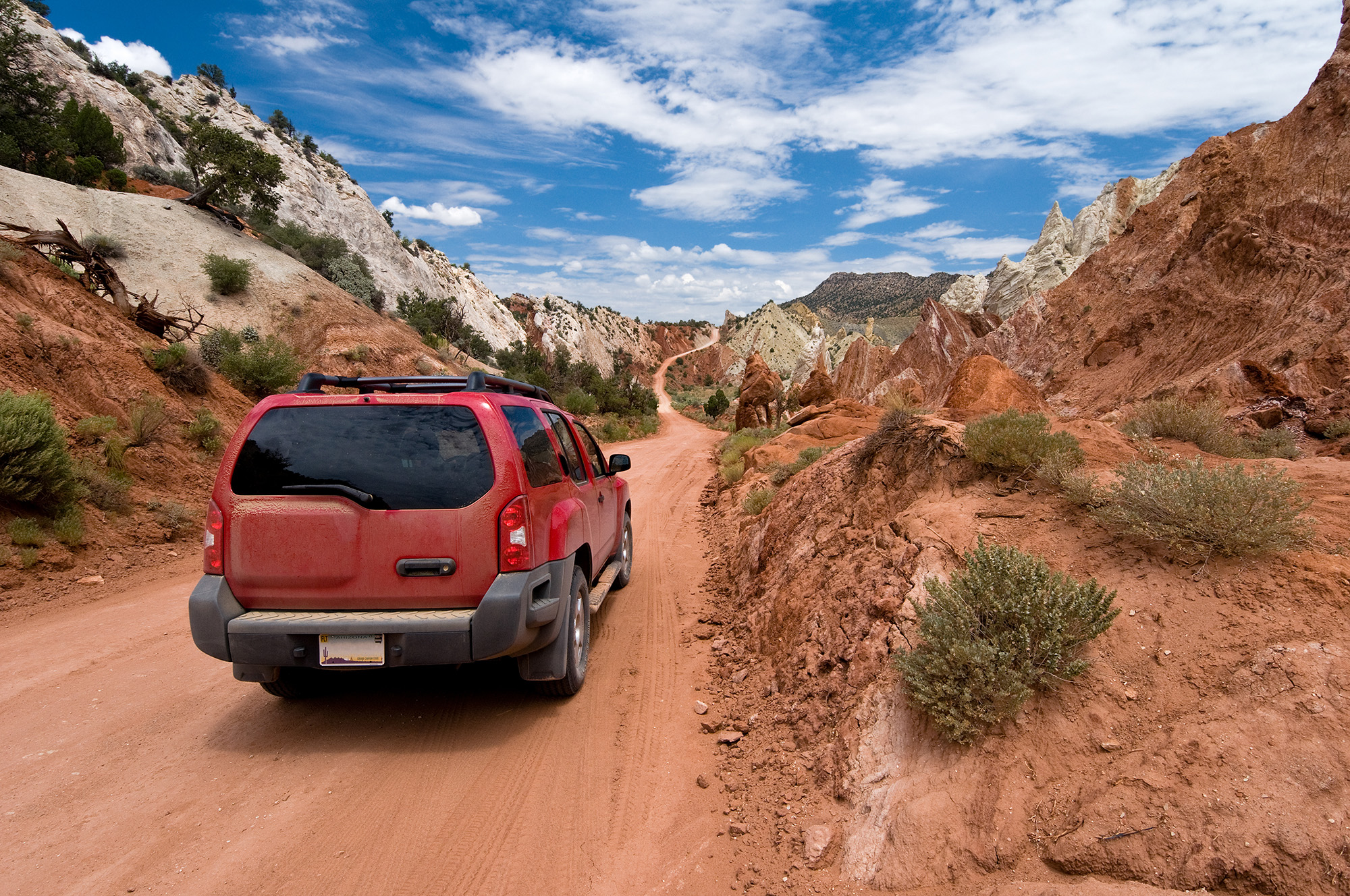 SUV driving the Cottonwood Canyon Road in Grand Staircase Escalante National Park, Utah