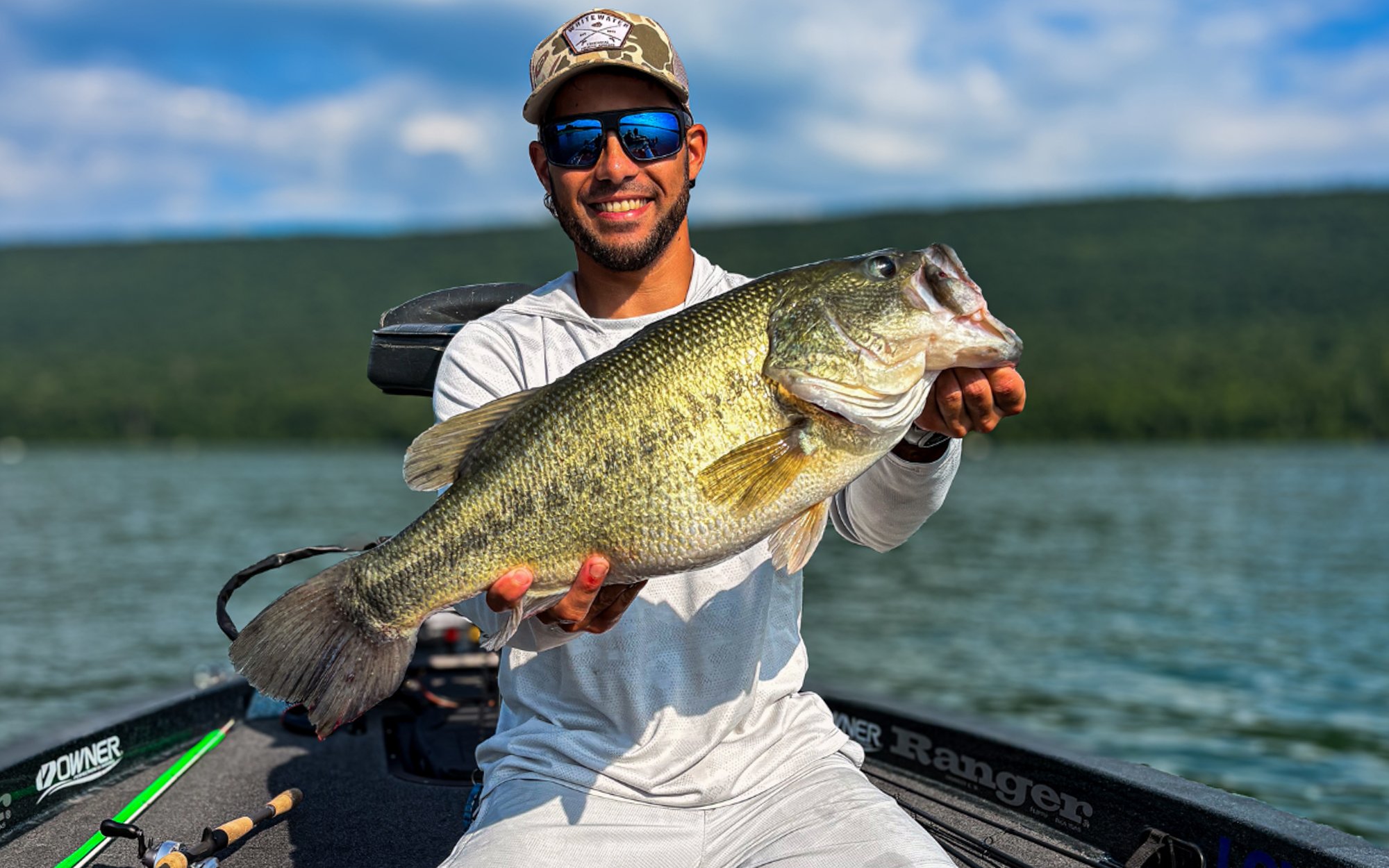 Fisherman Derek Horner holds out a nice 8 pound bass caught on an urchin lure.