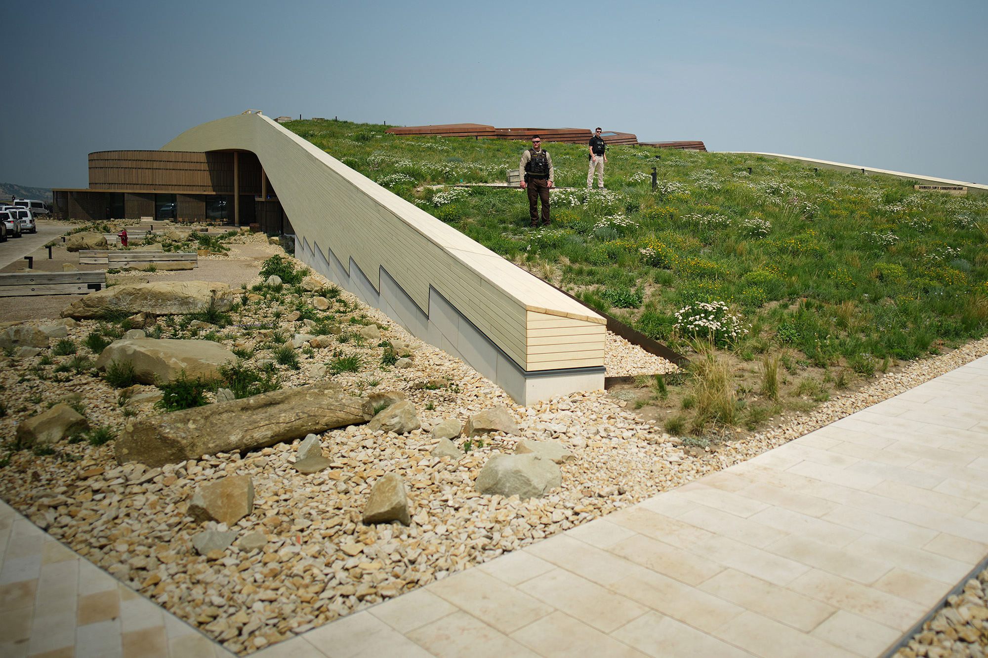 MEDORA, NORTH DAKOTA - JULY 01: Members of law enforcement look on ahead of a dedication ceremony for the Theodore Roosevelt Presidential Library on July 01, 2026 in Medora, North Dakota. The privately funded library and museum, located at the edge of Theodore Roosevelt National Park in North Dakota's Badlands, will hold its grand opening on July 4th to coincide with the nation's 250th anniversary. (Photo by Andrew Harnik/Getty Images)