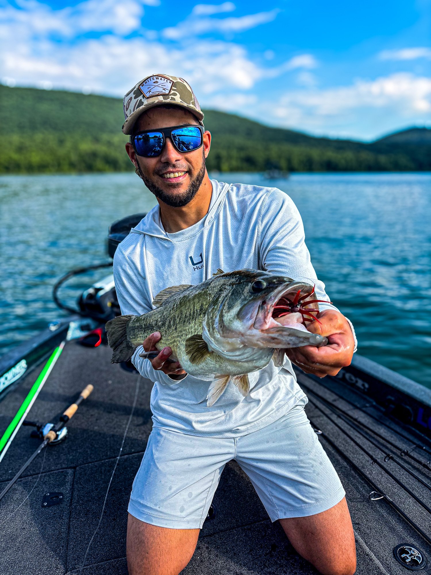 Fisherman holds out a nice 8 pound bass caught on an urchin lure.