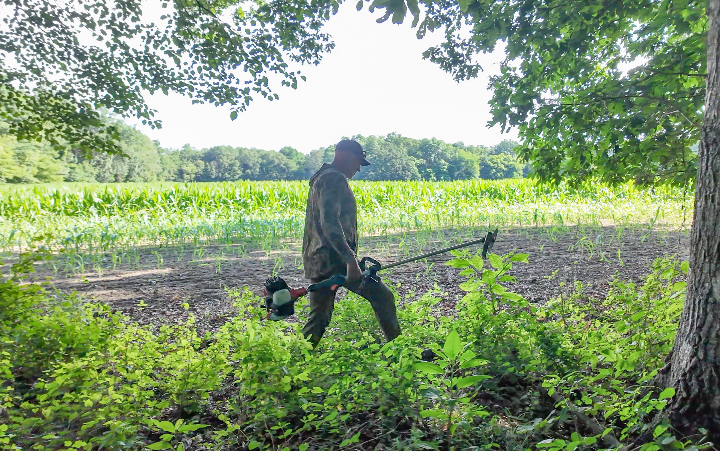 Andy Morgan carries a weed whacker.