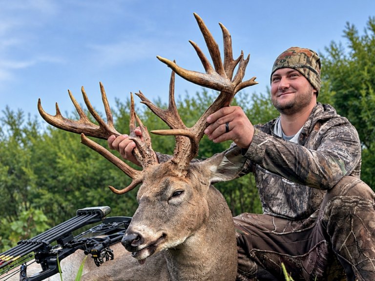 A photo of a bowhunter with a nice deer.