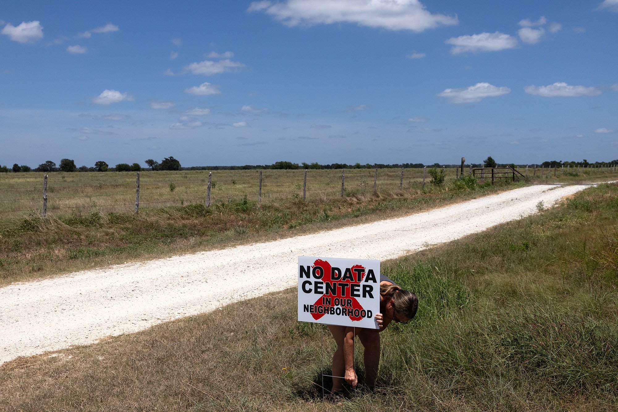 JEWETT,TEXAS - JULY 28: Donna Hull stakes a "no data center" signs on her property's fence line next to the proposed Crusoe data center, Tuesday, July 28, 2026, in Jewett. (Photo by Antranik Tavitian/For The Washington Post via Getty Images)