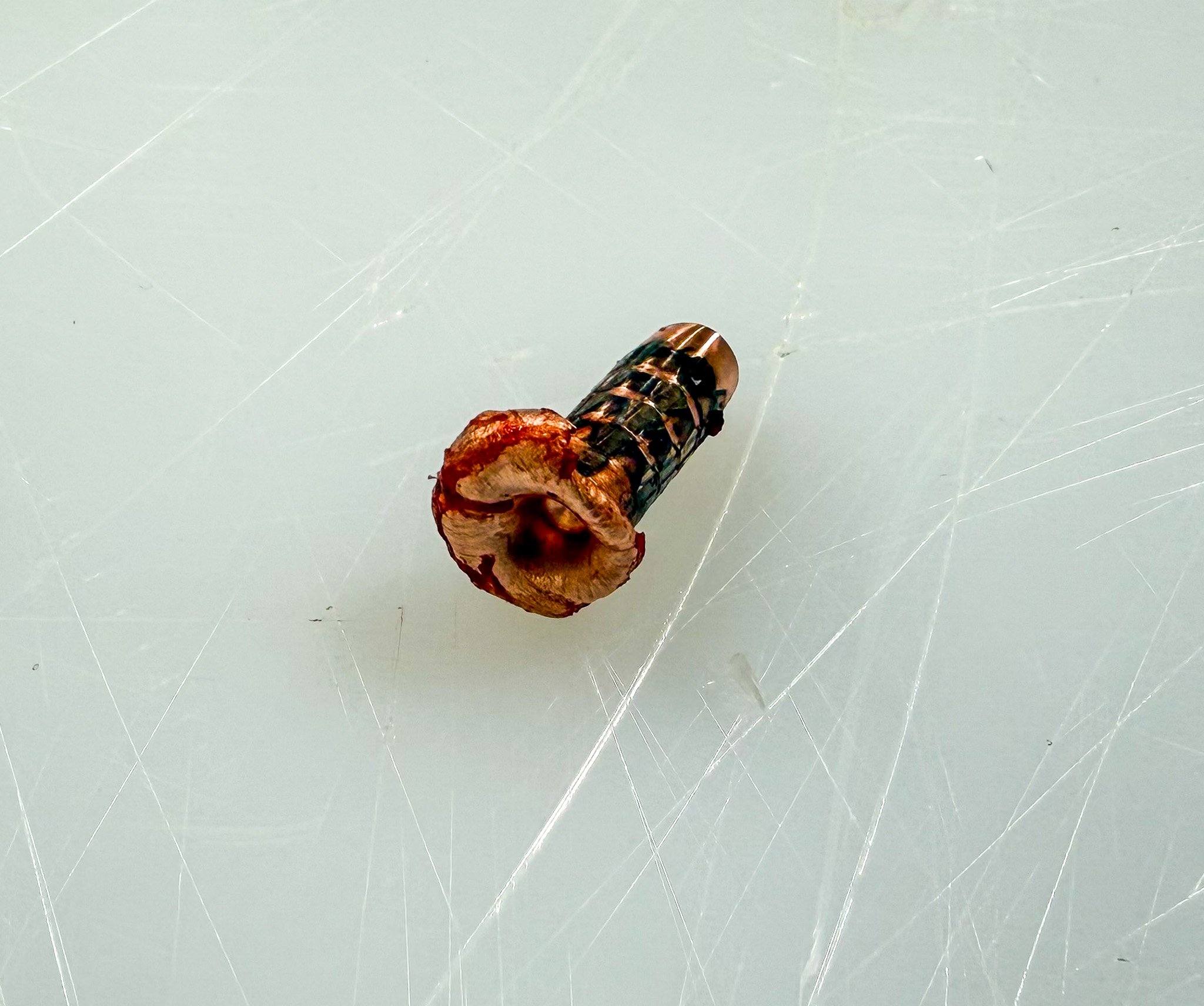 A mushroomed bullet on a cutting board