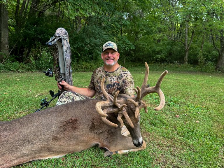 A bowhunter with a nice velvet deer
