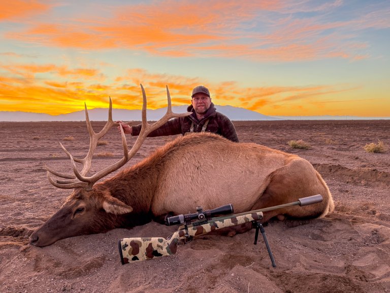 A photo of a hunter with a nice bull in Colorado.