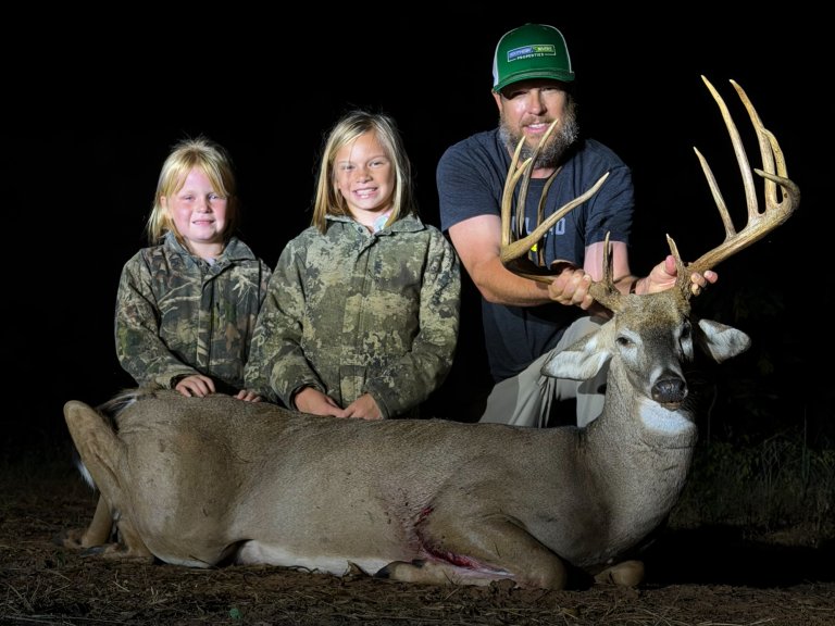 A photo of a hunter with a nice typical georgia buck that could be the new state record.