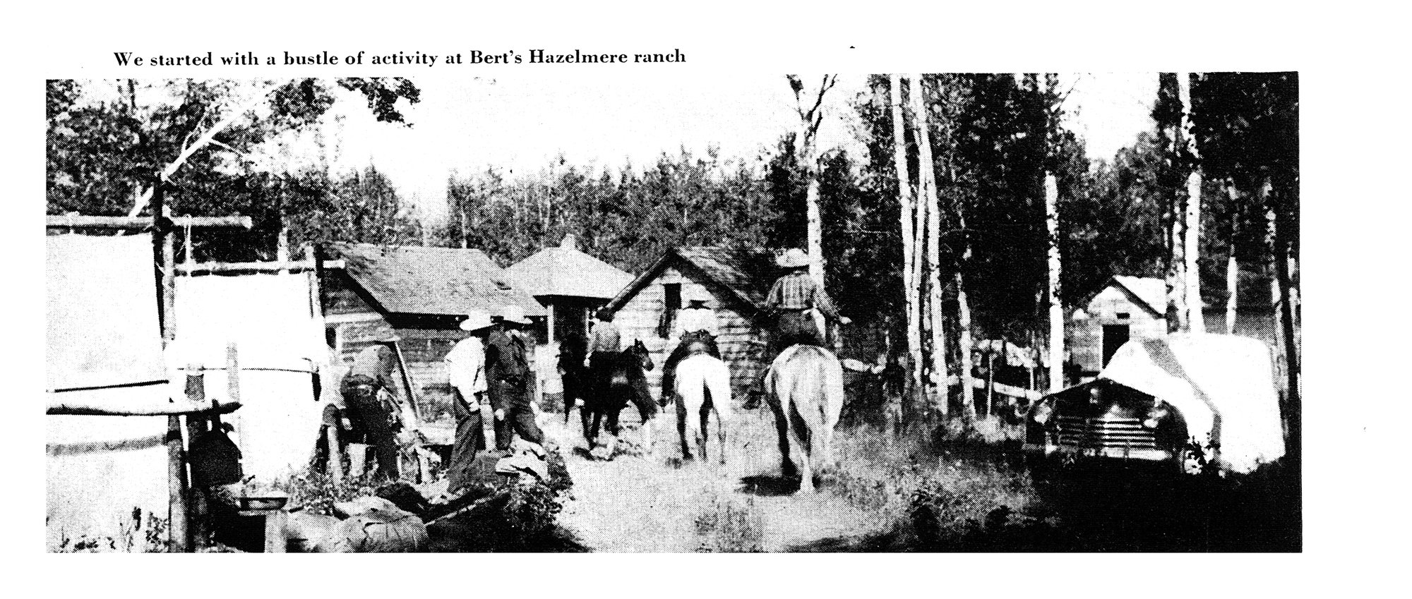 Black-and-white photo of riders and pack horses setting out from a ranch yard with log buildings, tents and a parked car.